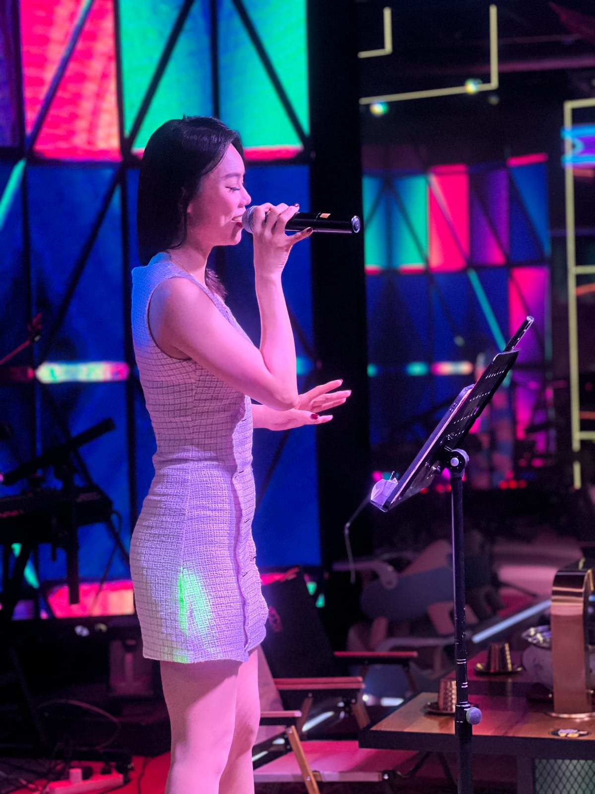 A live singer performing on stage at Xin Yan Korean Live Show BBQ