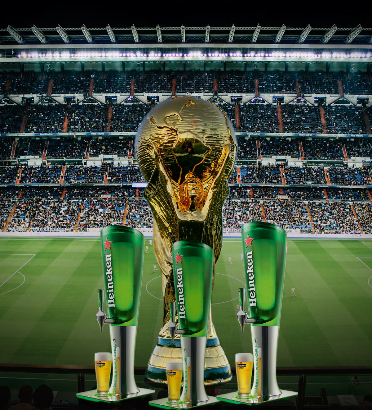 The FIFA World Cup trophy in front of a floodlit football stadium packed with fans